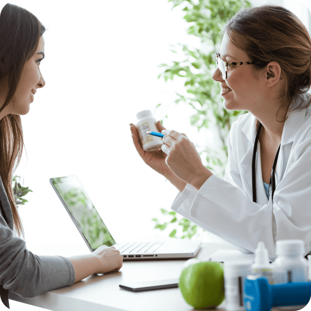 A physician covering medication instructions with a patient